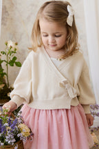 Gilet élégant en coton crème et lurex, avec cache-cœur et manches ballon