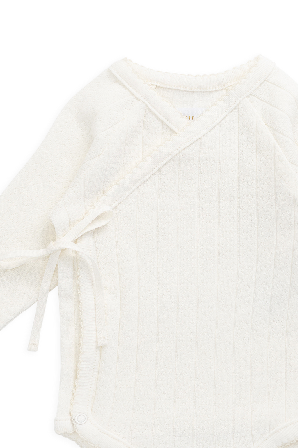 Bodysuit romantique en coton parcheminé et élasthanne avec imprimé cœurs ajourés et devant cache-cœur