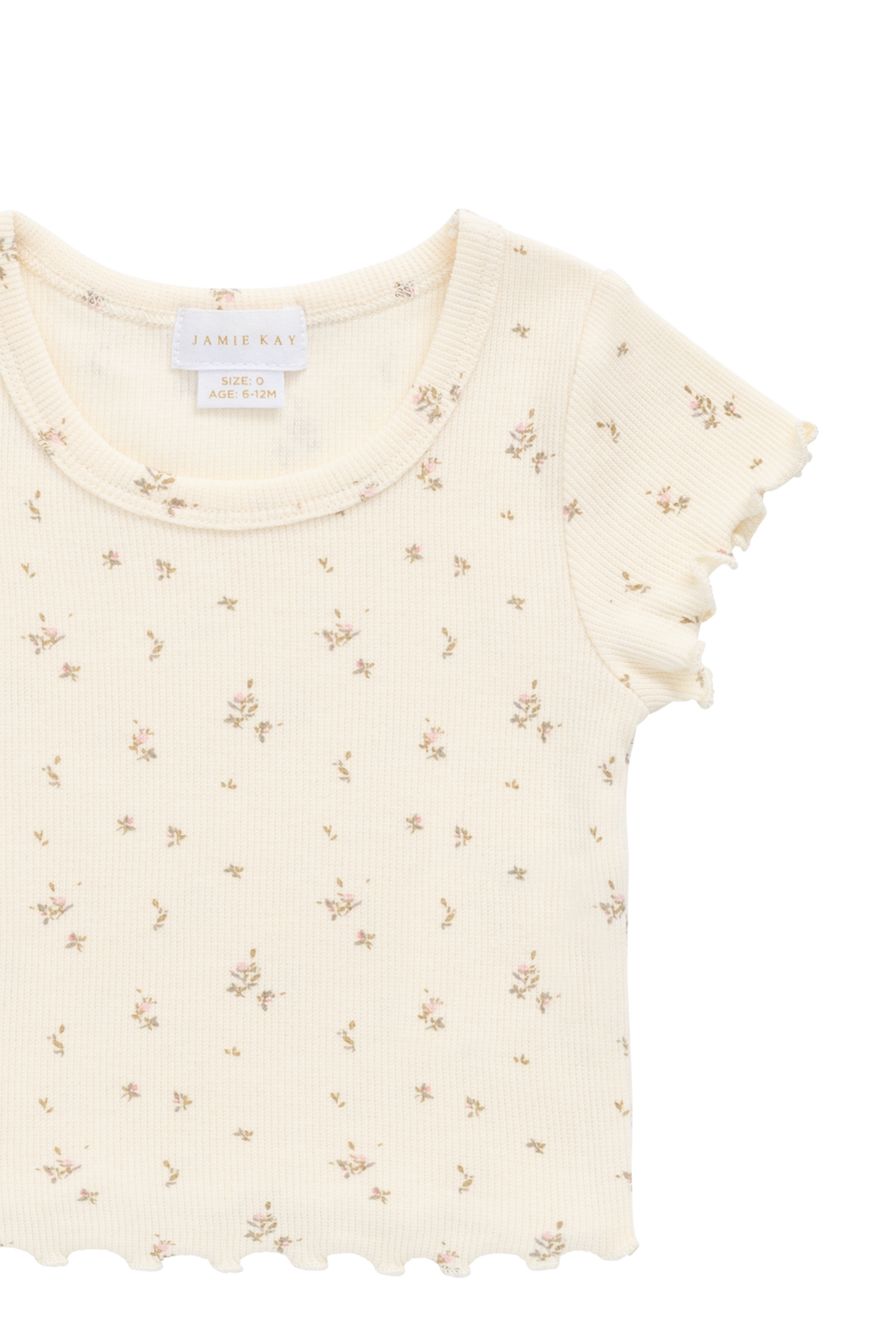 Haut romantique en modal et coton à fleurs crème avec texture finement côtelée et bords festonnés